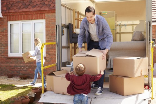 Small removals team handling furniture in Honoroak